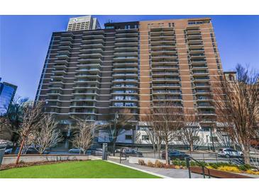 Striking exterior shot of a high rise building with a manicured green lawn and street view at 620 Peachtree Ne St # 1206, Atlanta, GA 30308