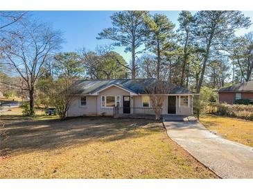 Brick ranch home with a spacious yard and driveway at 2190 Greystone Way, Decatur, GA 30032