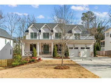 Two-story farmhouse with white siding, gray roof, and a charming front porch at 1926 Fairway Ne Cir, Brookhaven, GA 30319