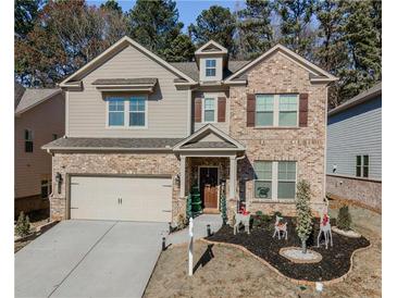 Two-story brick home with a landscaped yard and attached garage at 3227 Hidden Valley Cir, Lawrenceville, GA 30044