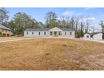 Newly renovated house with a large front yard and long driveway at 1320 Melbenan Dr, Atlanta, GA 30311