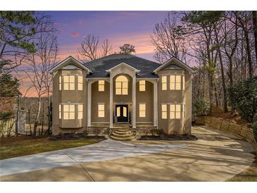 Stunning two-story home with a classic design, landscaped front yard and a spacious driveway at 1350 Eryn Cir, Suwanee, GA 30024