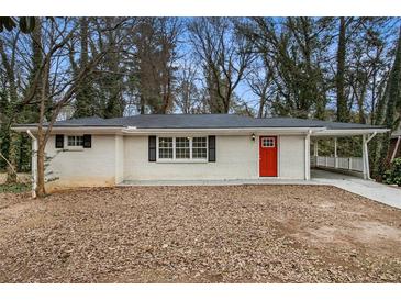 Newly renovated brick ranch home with a red front door and covered porch at 5531 Wild Cherry Sw Dr, Mableton, GA 30126