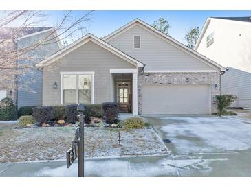 Gray exterior boasts a brick accent and two-car garage at 630 Eagles Lndg, Woodstock, GA 30188