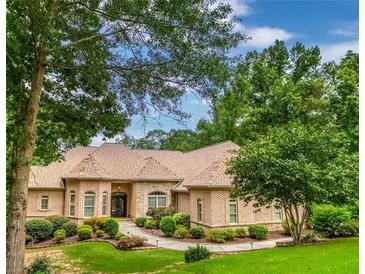 Brick home with landscaped yard and large driveway at 490 Revenna Trl, Fayetteville, GA 30214