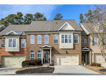 Brick front exterior of charming townhome with two-car garage at 10444 Park Walk Pt, Alpharetta, GA 30022