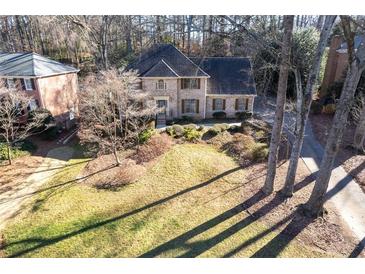 Charming two-story brick home with a well-manicured lawn and mature trees, offering great curb appeal at 4116 River Cliff Chase Se, Marietta, GA 30067