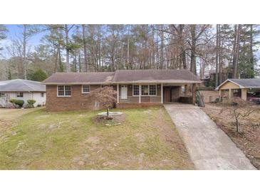 Brick ranch house with a driveway and landscaped yard at 4334 Greenleaf Sw Cir, Atlanta, GA 30331