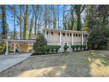 Ranch style home with carport, mature trees, and well-manicured lawn at 3144 Granada, Atlanta, GA 30344