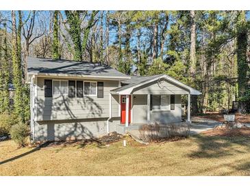 Ranch style home with gray exterior, red door, and landscaped yard at 2456 Colorado Sw Trl, Atlanta, GA 30331