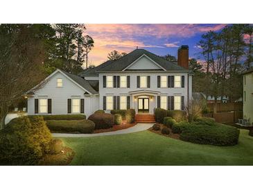 Two-story house with white siding, black shutters, and a manicured lawn at 5060 Rosedown Pl, Roswell, GA 30076