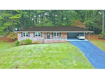 Brick ranch house with carport and large yard at 1792 Hammond Woods Sw Cir, Marietta, GA 30008