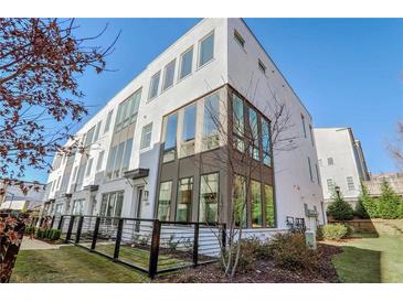 Modern three-story townhome with a sleek design and fenced yard at 308 Gibson Se St, Atlanta, GA 30316