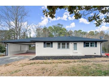 Newly renovated ranch home with carport and landscaped yard at 1955 E Lake Dr, Marietta, GA 30066