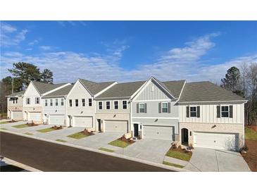 Row of charming townhouses with attached garages and landscaping at 3311 Cranston Ln, Kennesaw, GA 30144