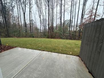 Private backyard with grassy lawn and concrete patio at 3305 Cranston Ln, Kennesaw, GA 30144