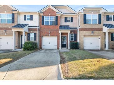 Brick front townhouse with 2-car garage and landscaped lawn at 3135 Bernauer Trce, Atlanta, GA 30360