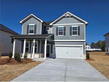 Charming two-story home featuring a two-car garage and welcoming front porch in a Gathering-friendly neighborhood at 2422 Brown Dove Way Lot 70, Grayson, GA 30017