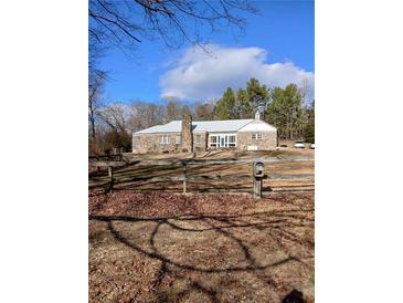 Stone house with metal roof, large yard, and trees at 650 Kingston Highway, Kingston, GA 30145