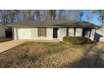 Ranch style home with attached garage and landscaped lawn at 206 Sherwood Loop, Mcdonough, GA 30253