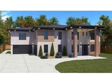 Modern two-story home with brick and wood siding, attached garage, and landscaped lawn at 1349 Oak Rd, Lilburn, GA 30047