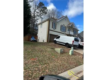 Two-story house with a brown roof, light stucco, brown trim, and an attached garage at 255 Thornbush Ln, Lawrenceville, GA 30046