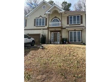 Two-story house with a brown door and white balcony at 255 Thornbush Ln, Lawrenceville, GA 30046