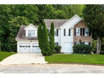 Charming two-story home with a two-car garage and a combination of stone and siding facade at 2295 Creekview Trl, Decatur, GA 30035