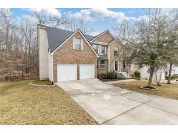 Two-story brick home with a two-car garage and manicured lawn at 6834 Fireside Ln, South Fulton, GA 30349