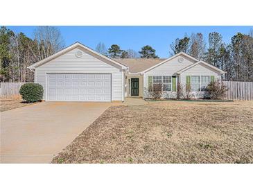 White ranch house with attached garage and a spacious yard at 45 Kendall Ln, Covington, GA 30014