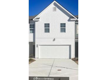 White two-story home with attached garage and driveway at 1195 Westhampton Way # 144, Villa Rica, GA 30180