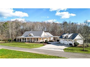 Luxury home with detached garage, large front porch, and expansive lawn at 5288 East Cherokee Dr, Canton, GA 30115