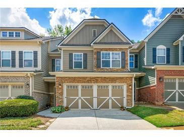 Charming townhome featuring a stone and siding facade with an attached two-car garage in a well-manicured community at 1503 Dolcetto Nw Trce # 2, Kennesaw, GA 30152