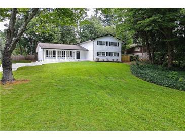 Ranch style home with a large front yard and mature trees at 4617 Dunover Cir, Dunwoody, GA 30360