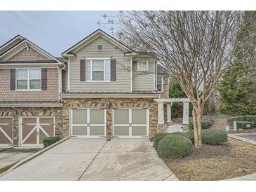Two-story townhome with stone accents and a two-car garage at 1600 Watercress Se Ct, Mableton, GA 30126