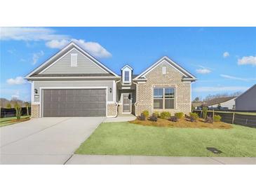 Brick and shingle one-story home with a two-car garage at 2798 Turnwater St, Hoschton, GA 30548