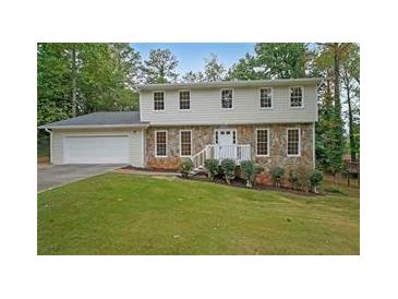 Two-story house with stone accents and a spacious lawn at 1529 Bell Flower Ct, Stone Mountain, GA 30088