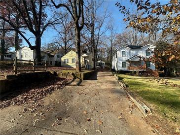 Cozy yellow house with a spacious yard and tree-lined street at 1591 Woodland Se Ave, Atlanta, GA 30316