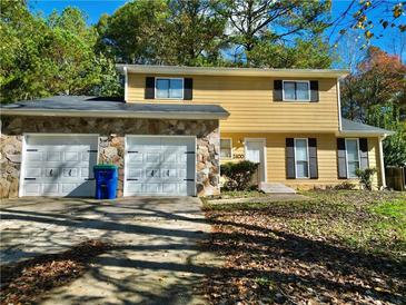 Two-story house with stone accents and a two-car garage at 2400 Reynolds Rd Sw, Atlanta, GA 30331