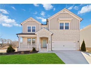 Two-story house with light beige siding and a green door at 2131 Landsburg Way, Lawrenceville, GA 30043