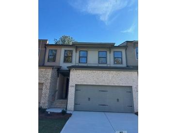 Brick front exterior of charming townhome with 2-car garage at 1346 Lucan Ln # Wc227, Lawrenceville, GA 30043