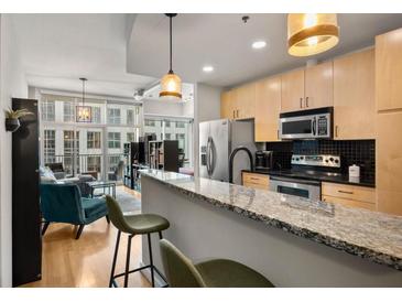 Modern kitchen with stainless steel appliances and granite countertops at 943 Peachtree Ne St # 809, Atlanta, GA 30309