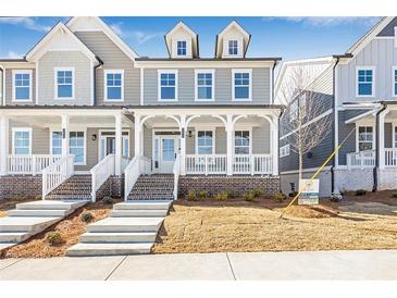 Two-story craftsman home with front porch and brick facade at 152 Palm St, Holly Springs, GA 30115