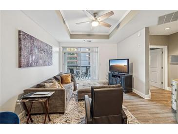 Spacious living room with modern furniture and access to a balcony at 325 E Paces Ferry Ne Rd # Apt 710, Atlanta, GA 30305