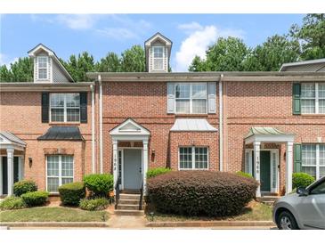 Brick townhouse exterior with landscaping and a gray door at 1968 Drennon Ave, Austell, GA 30106