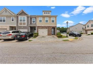 Attractive townhome with two-car garage and landscaped front yard at 5076 Longview Walk, Decatur, GA 30035