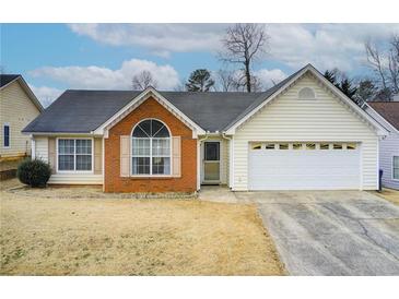 Brick and vinyl-sided house with a two-car garage at 990 Avalon Dr, Lawrenceville, GA 30044