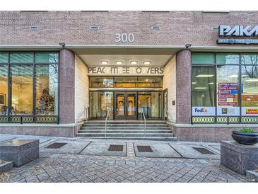 PeachTree Towers building entrance with double doors and landscaping at 300 W Peachtree St # 12A, Atlanta, GA 30308