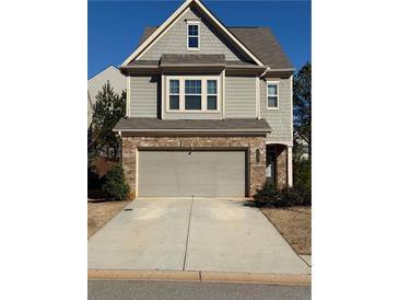 Two-story house with gray siding, brick accents, and a two-car garage at 3109 Baylor Cir, Mcdonough, GA 30253
