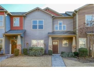 Two-story townhome with gray siding, brick accents, and a welcoming front porch at 4204 Mastic Pointe # 24, Acworth, GA 30101